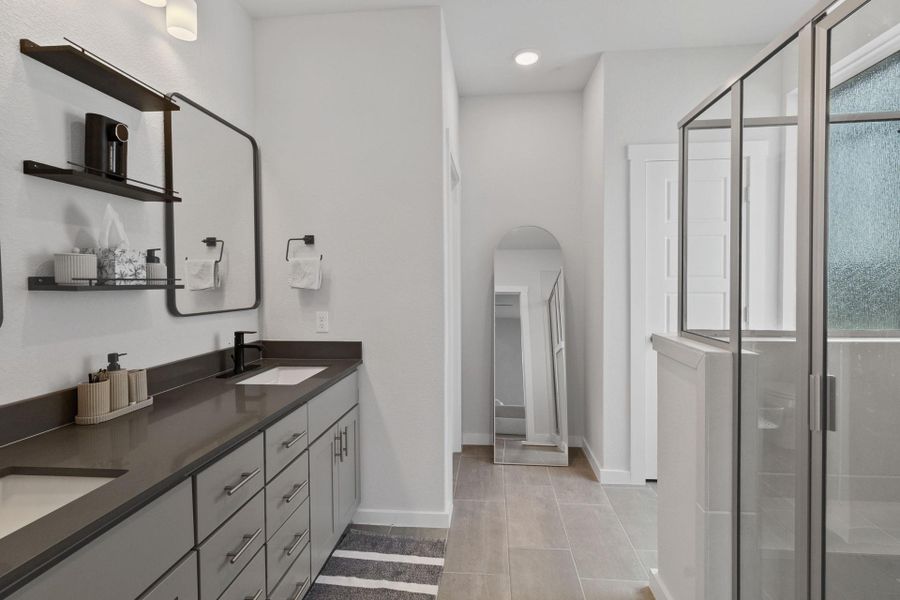 Full bath with dual vanity/sinks, a shower