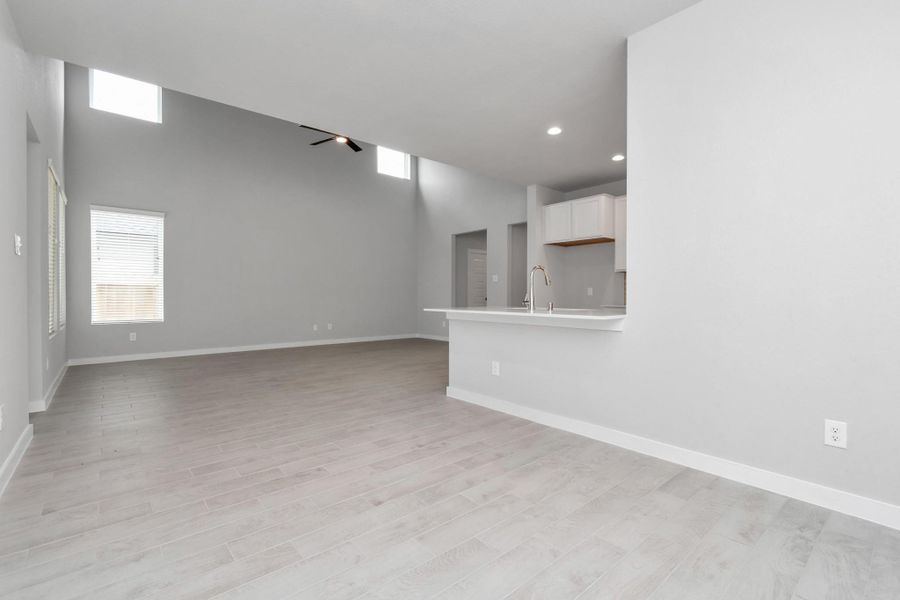 Craft enduring memories with loved ones around the table in this roomy dining area. It features stylish flooring, personalized paint, and is conveniently situated next to the family room and kitchen, fostering an open and inclusive ambiance. Sample photo of completed home with similar floor plan. Actual colors and selections may vary.