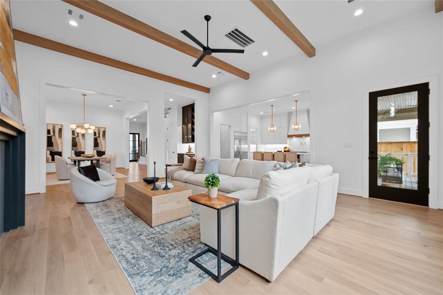 Open floor plan with huge great room with 13' ceiling and white oak wood beam ceiling detail open to dining room and kitchen overlooking backyard