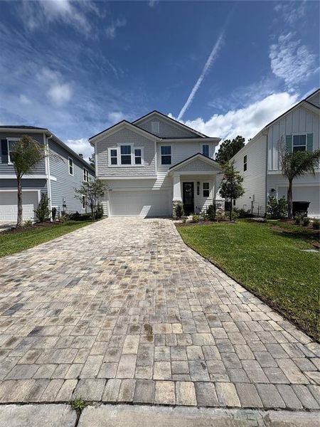Front exterior of a new home in Brook Forest, St. Augustine, FL, highlighting curb appeal (Image 1). Front exterior of a new home in Brook Forest, St. Augustine, FL, highlighting curb appeal (Image 1).