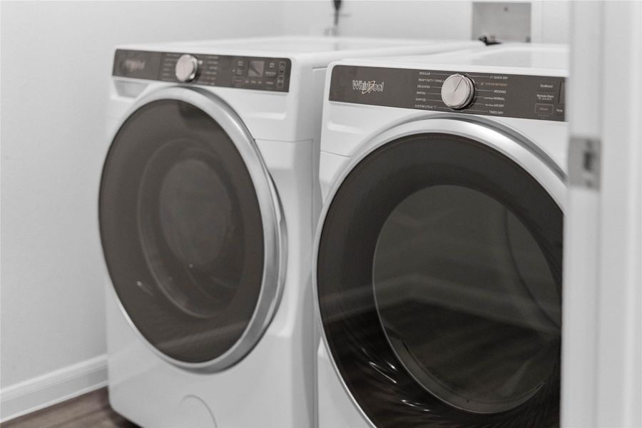 This dedicated laundry room comes equipped with a Whirlpool washer and dryer set, ready for immediate use. This dedicated laundry room comes equipped with a Whirlpool washer and dryer set, ready for immediate use.