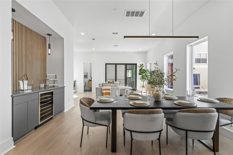 At the intersection of design and hospitality, the custom dry bar becomes a focal point of intention—flanked by vertical wood slats that echo the home’s Scandinavian influence. Just steps from the dining and living areas, it invites effortless hosting and everyday indulgence, whether it’s a pre-dinner pour or weekend brunch with friends. Thoughtfully placed and beautifully executed, this is where form meets function with a quiet confidence. At the intersection of design and hospitality, the custom dry bar becomes a focal point of intention—flanked by vertical wood slats that echo the home’s Scandinavian influence. Just steps from the dining and living areas, it invites effortless hosting and everyday indulgence, whether it’s a pre-dinner pour or weekend brunch with friends. Thoughtfully placed and beautifully executed, this is where form meets function with a quiet confidence.