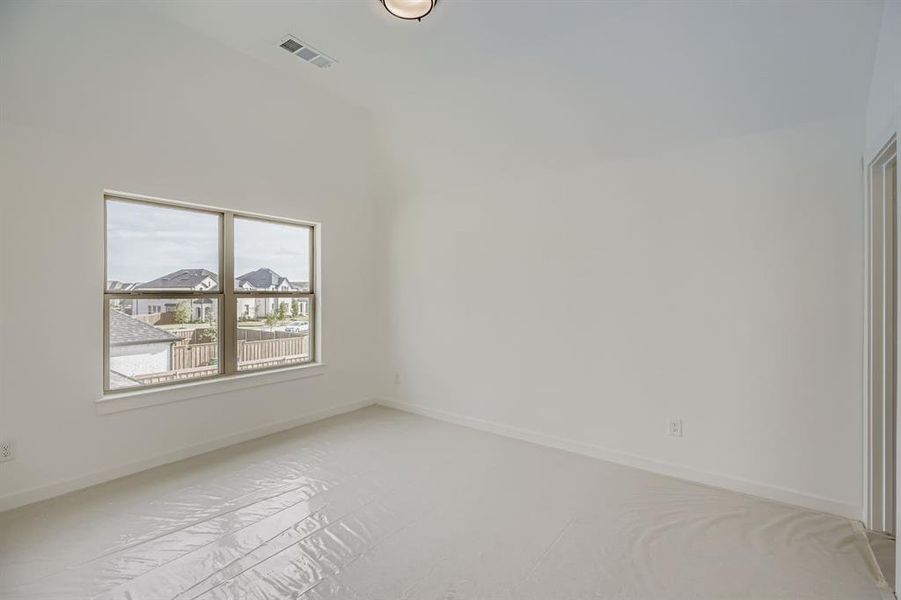Spare room featuring lofted ceiling and a residential view Spare room featuring lofted ceiling and a residential view