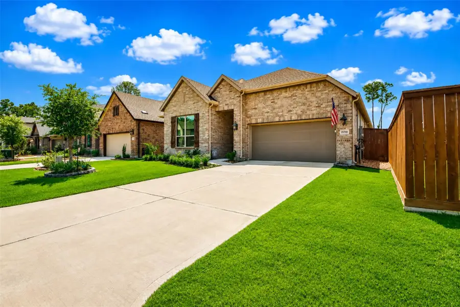 Front exterior of a new home in The Highlands, Porter, TX, highlighting curb appeal (Image 2). Front exterior of a new home in The Highlands, Porter, TX, highlighting curb appeal (Image 2).