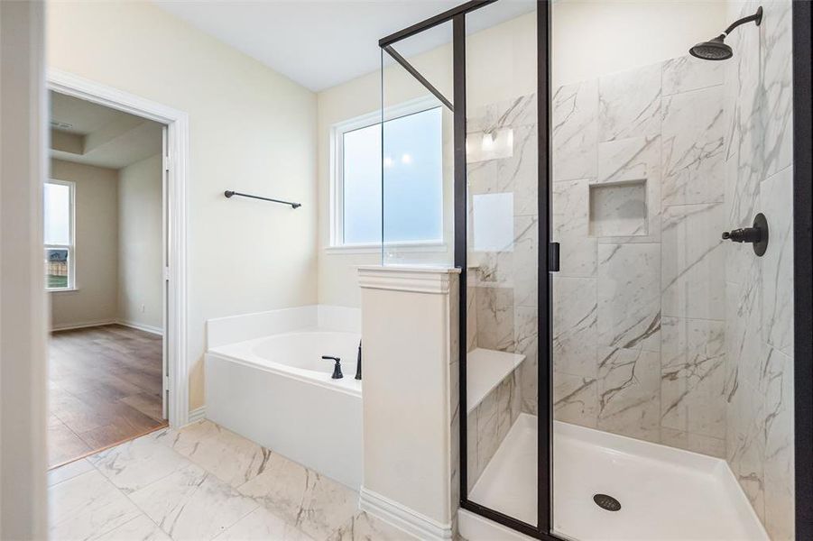 Bathroom with marble finish flooring, a garden tub, a marble finish shower, and healthy amount of natural light