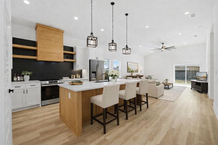Virtually staged, open concept kitchen and living area.
