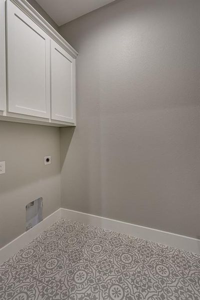 Laundry room with cabinets and hookup for an electric dryer