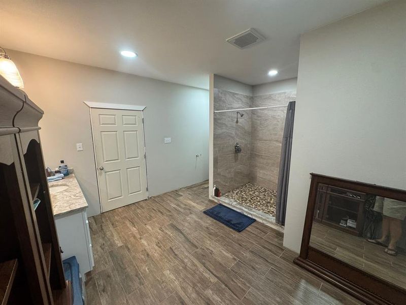 Bathroom featuring vanity, dark wood finished floors, a shower stall, and recessed lighting Bathroom featuring vanity, dark wood finished floors, a shower stall, and recessed lighting
