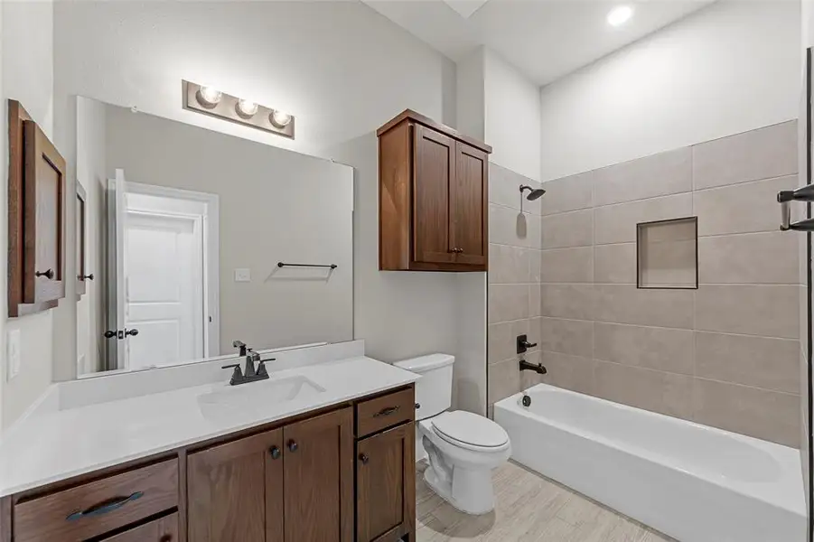 Full bathroom with shower / washtub combination and vanity