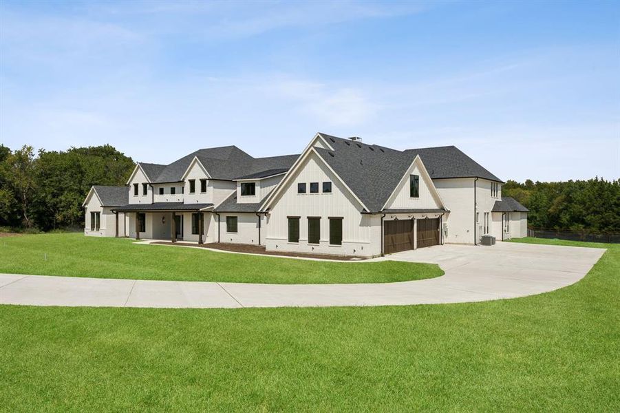 The oversized 4-car garage is complemented by a graded parking pad ready for expansion. The oversized 4-car garage is complemented by a graded parking pad ready for expansion.