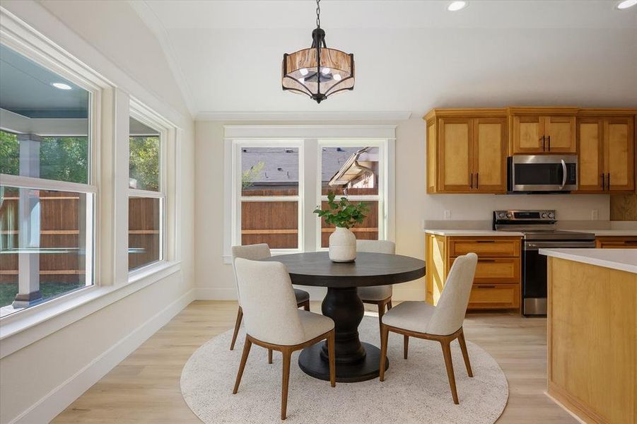 Dining space featuring recessed lighting, light wood-style flooring, and a chandelier