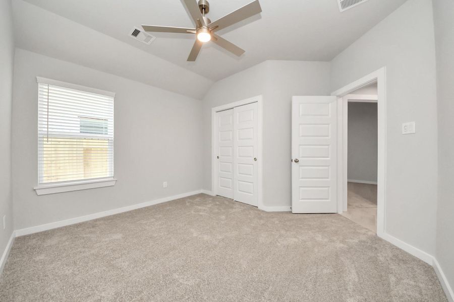 Generously sized secondary bedrooms featuring spacious closets, soft and inviting carpeting underfoot, large windows allowing plenty of natural light, and the added touch of privacy blinds for your personal retreat. Sample photo of completed home with similar floor plan. Actual colors and selections may vary. Generously sized secondary bedrooms featuring spacious closets, soft and inviting carpeting underfoot, large windows allowing plenty of natural light, and the added touch of privacy blinds for your personal retreat. Sample photo of completed home with similar floor plan. Actual colors and selections may vary.