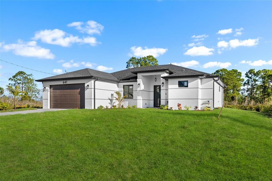 Front exterior of a new home in , Lehigh Acres, FL, highlighting curb appeal (Image 20).