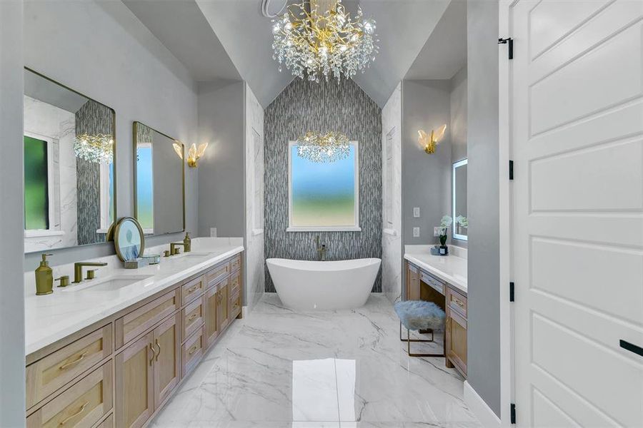 Bathroom with a tub to relax in, vanity, vaulted ceiling, and a wealth of natural light