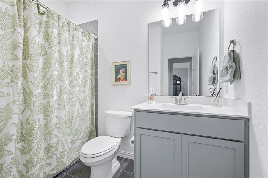 Full bath with vanity and a shower with curtain