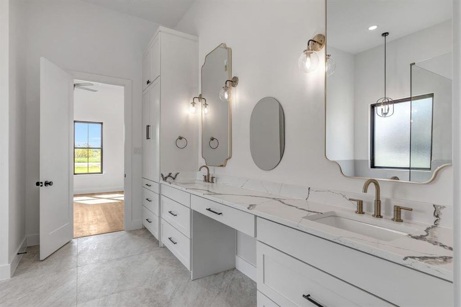 Full bath with double vanity and light tile patterned floors