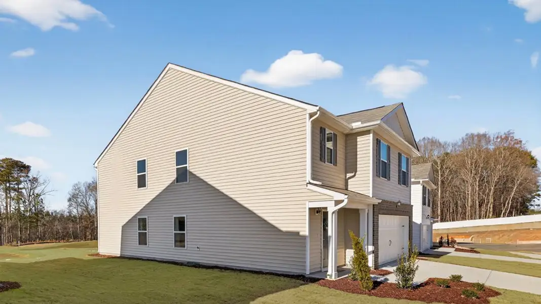 Front exterior of a new home in Laurel Oaks, Sanford, NC, highlighting curb appeal (Image 2). Front exterior of a new home in Laurel Oaks, Sanford, NC, highlighting curb appeal (Image 2).