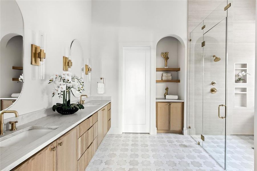Dual vanity with integrated sinks, light wood cabinetry, and brass hardware