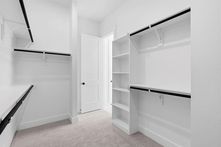 Thoughtfully laid out, the closet includes multiple hanging areas, built-in shelving, and ample storage options to keep clothing, shoes, and accessories neatly organized.