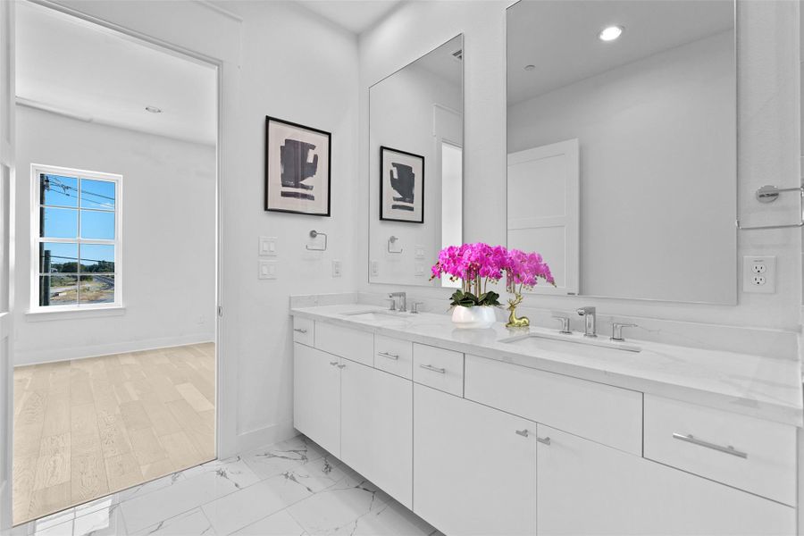 Full bath with double vanity, light marble finish floors, and recessed lighting