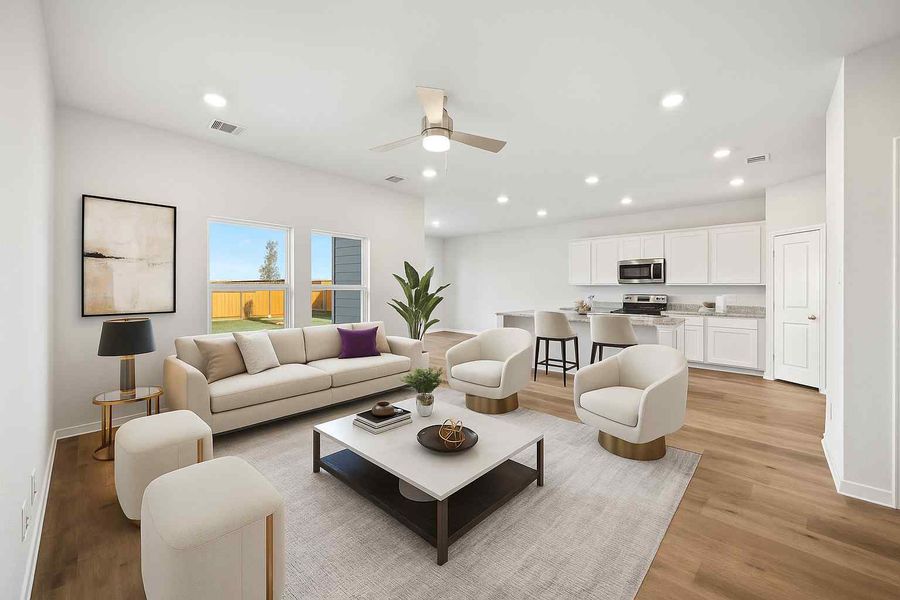 A large living room with a large white and black couch.