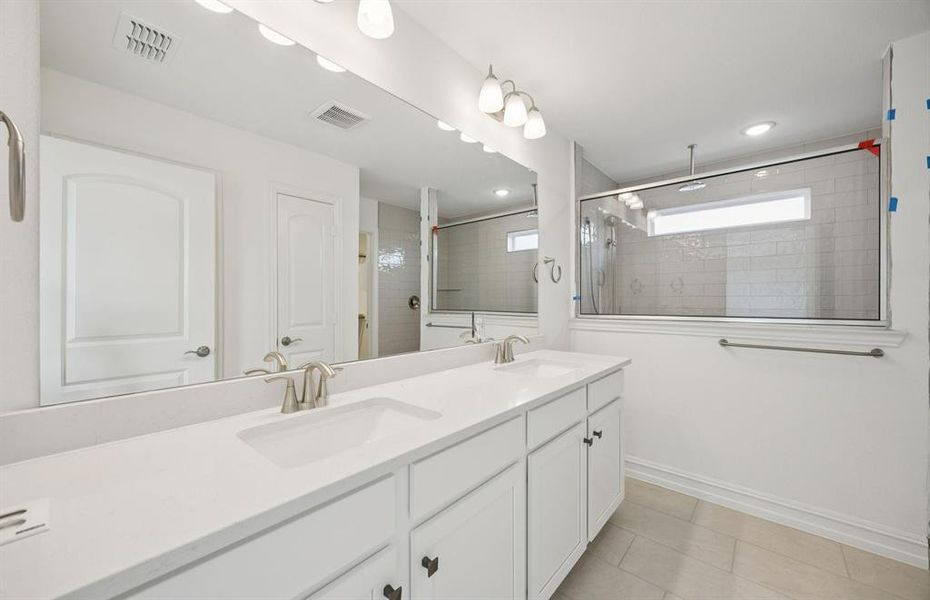Luxurious owner's bath complete with double sinks and a generous shower *Real home pictured Luxurious owner's bath complete with double sinks and a generous shower *Real home pictured
