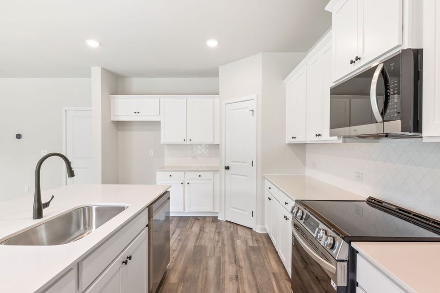A kitchen with white cabinets. A kitchen with white cabinets.