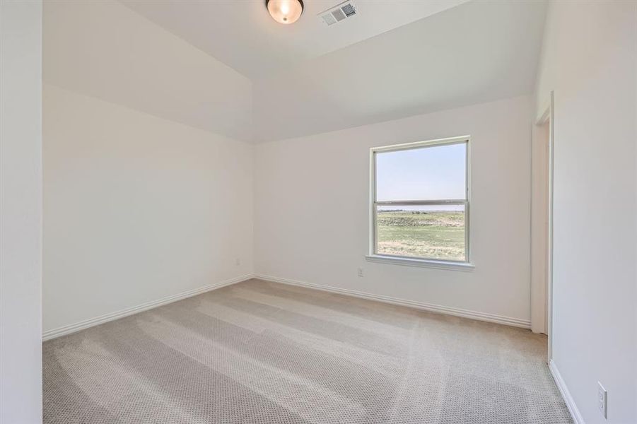 Secondary bedroom with lofted ceiling