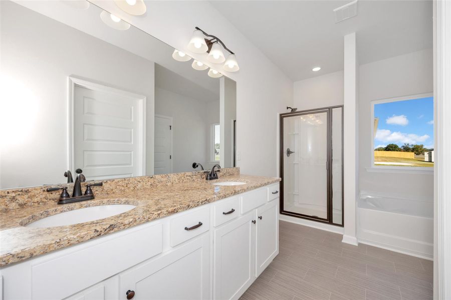 The Pearson- Owner's Bathroom with Garden Tub and Walk-in Shower. Home under construction. Sample floor plan photo used for illustrative purposes only. Upgrades, selections options, and colors will vary.