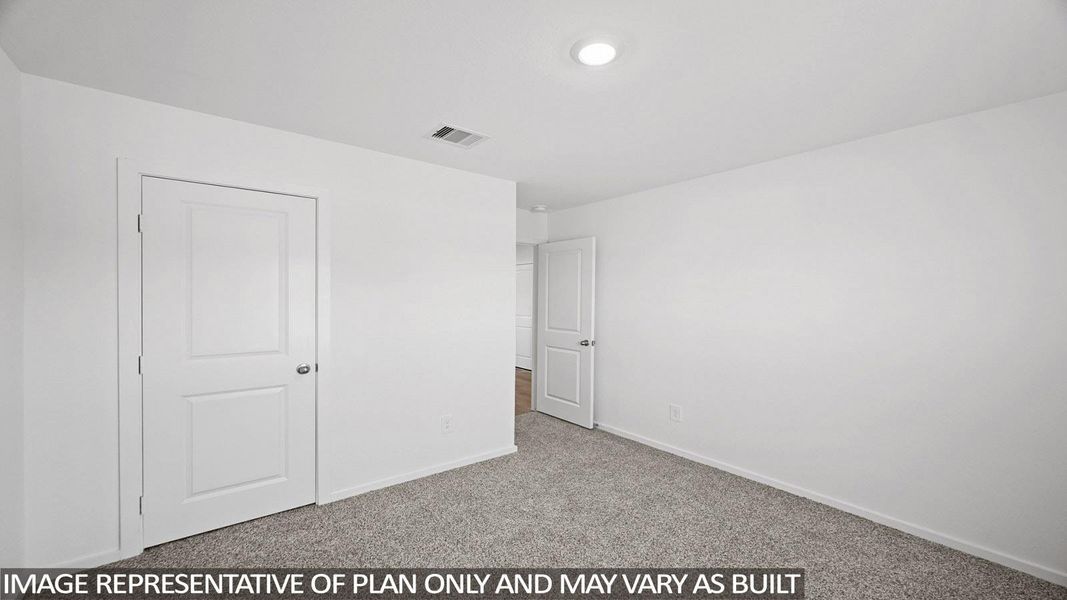 Unfurnished bedroom featuring light colored carpet and baseboards