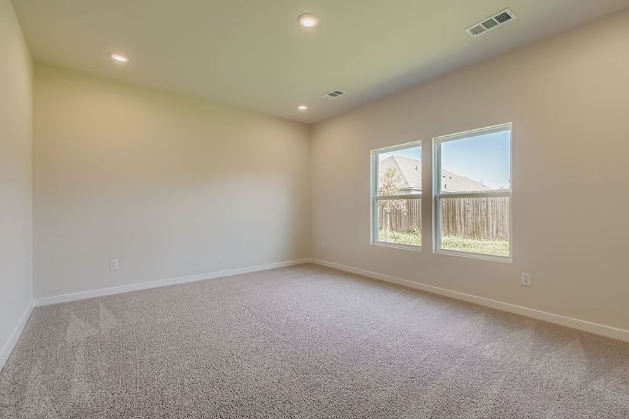 A room with a window and carpet.