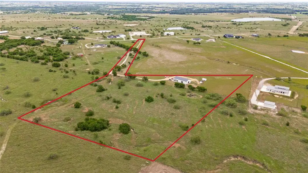 Expansive rural acreage featuring a main residence, additional structures, and a long private driveway Expansive rural acreage featuring a main residence, additional structures, and a long private driveway