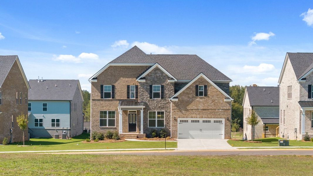 Front exterior of a new home in Heritage Pointe, Senoia, GA, highlighting curb appeal (Image 27). Front exterior of a new home in Heritage Pointe, Senoia, GA, highlighting curb appeal (Image 27).