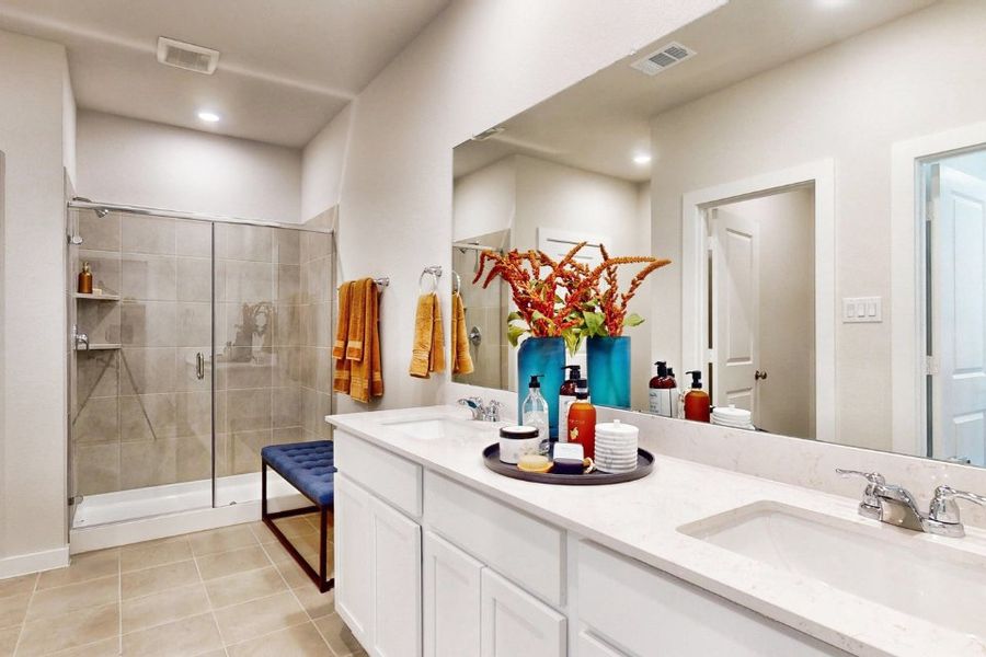 A bathroom with a sink and a shower.