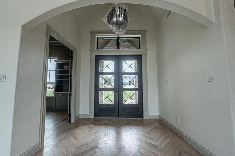 Foyer with arched walkways, a chandelier, and healthy amount of natural light Foyer with arched walkways, a chandelier, and healthy amount of natural light
