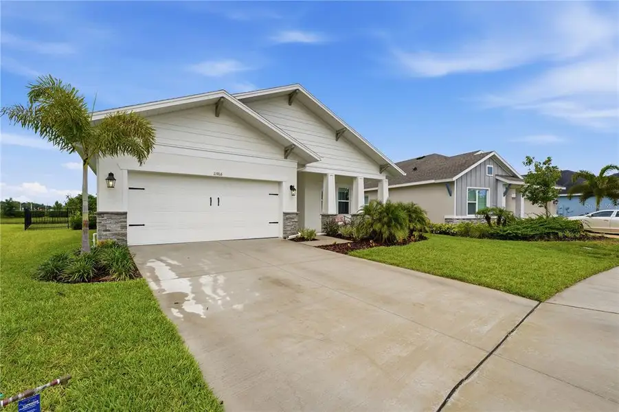 Front exterior of a new home in , Parrish, FL, highlighting curb appeal (Image 21).