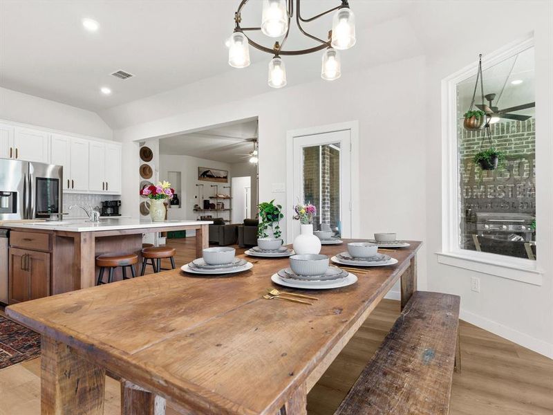 Light-filled dining space overlooking the property, offering scenic acreage views.