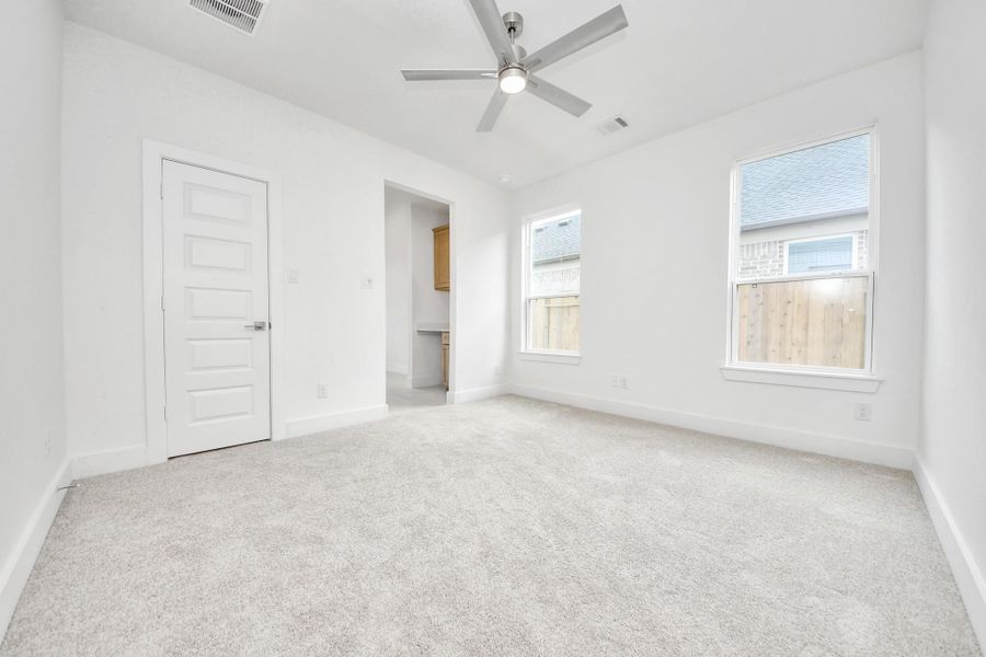 Secondary bedroom features plush carpeting, large windows that let in plenty of natural light, bright paint, and spacious closets. Secondary bedroom features plush carpeting, large windows that let in plenty of natural light, bright paint, and spacious closets.