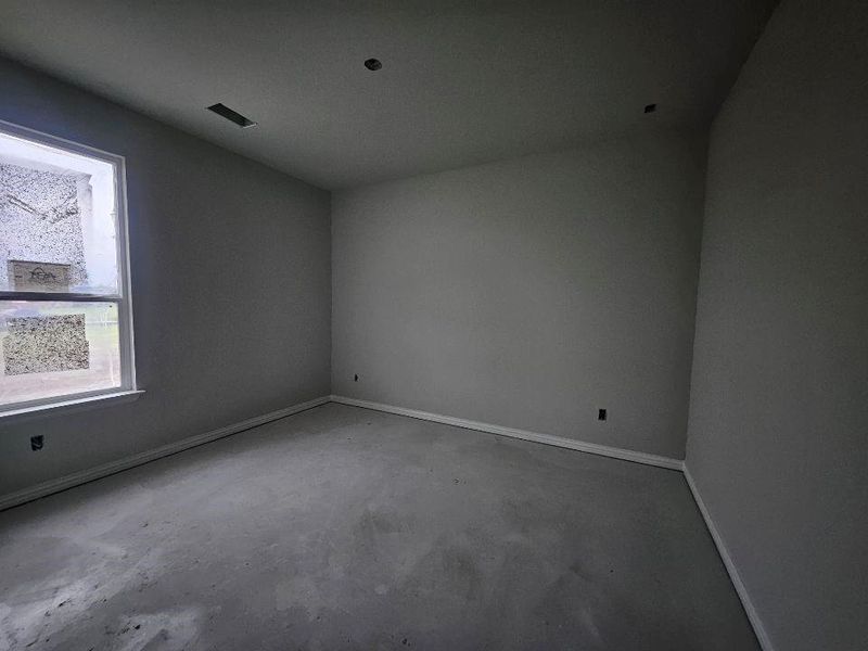 Neutral gray painted walls with white trim, a single window, and a ceiling-mounted ventilation register Neutral gray painted walls with white trim, a single window, and a ceiling-mounted ventilation register