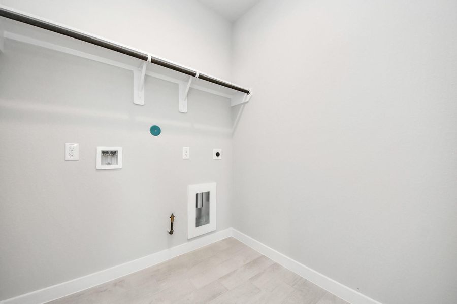 A perfect blend of functionality and comfort. Capture the essence of easy living with a first-floor laundry room, thoughtfully equipped with shelving for effortless organization. Both electric and gas connections available. A perfect blend of functionality and comfort. Capture the essence of easy living with a first-floor laundry room, thoughtfully equipped with shelving for effortless organization. Both electric and gas connections available.