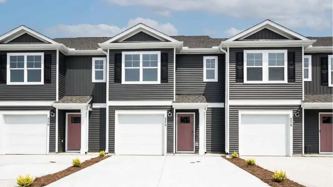 Front exterior of a new home in Townes at Seabrooke, Leland, NC, highlighting curb appeal (Image 1). Front exterior of a new home in Townes at Seabrooke, Leland, NC, highlighting curb appeal (Image 1).