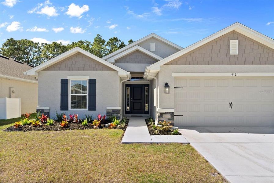 Front exterior of a new home in Pine Bluff, Spring Hill, FL, highlighting curb appeal (Image 21).