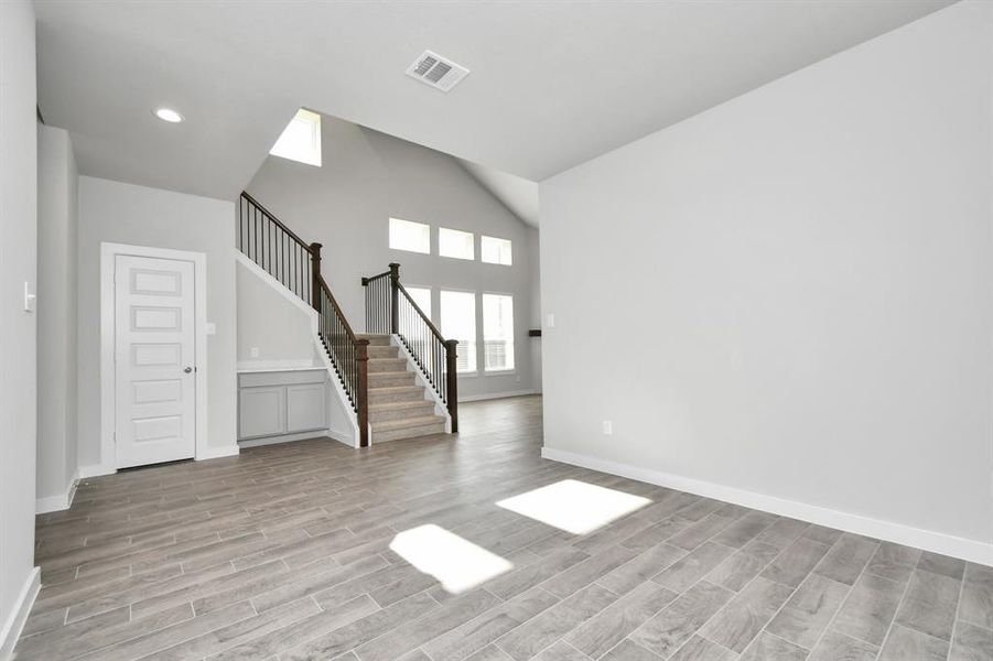 Create lasting memories with your family and friends at the dining table in this expansive dining room. Showcases sophisticated flooring, custom paint, and seamlessly connects to the family room and kitchen, providing an open and inviting atmosphere. Sample photo of completed home with similar floor plan. As-built interior colors and selections may vary.