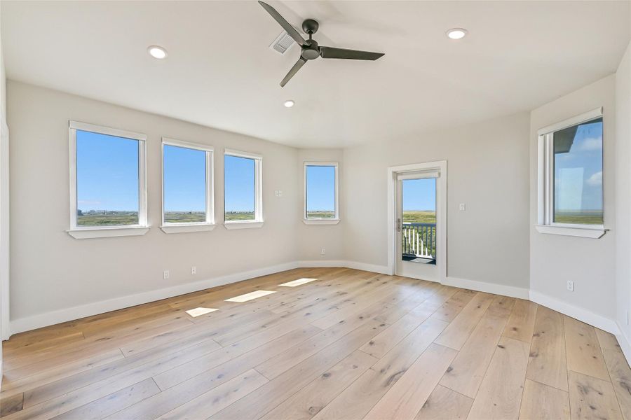 This bedroom offers the perfect balance of tranquility and inspiration—a true retreat designed for rest and rejuvenation. Expansive windows fill the space with natural light, while a gentle ceiling fan keeps the air cool and serene. Step through the private porch access and take in the bay breeze, where mornings begin with golden light and evenings end beneath a painted sky. With its generous layout and timeless finishes, this space is a blank canvas ready to reflect your personal style.