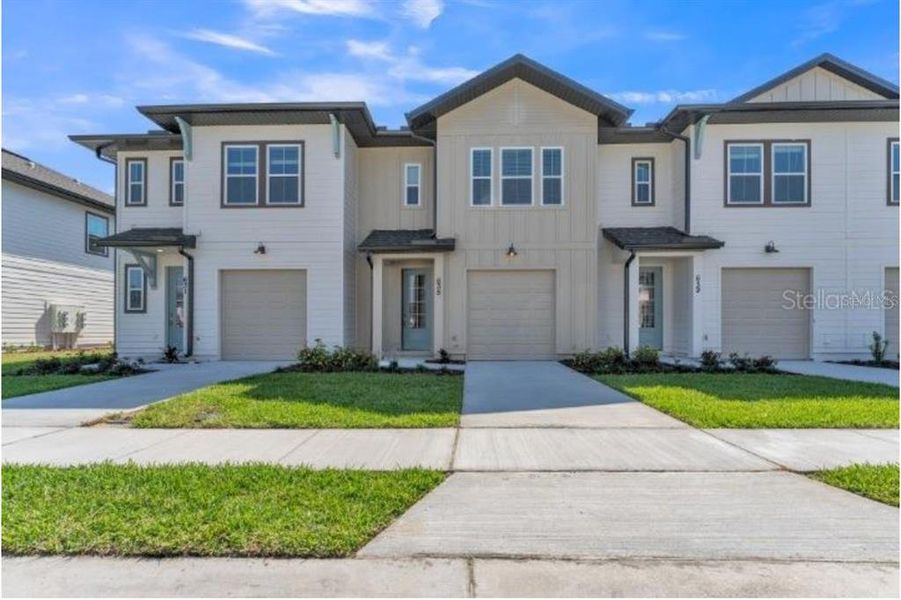 Front exterior of a new home in , Davenport, FL, highlighting curb appeal (Image 2).