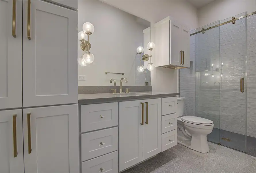 Bathroom with vanity, a shower stall, and toilet Bathroom with vanity, a shower stall, and toilet