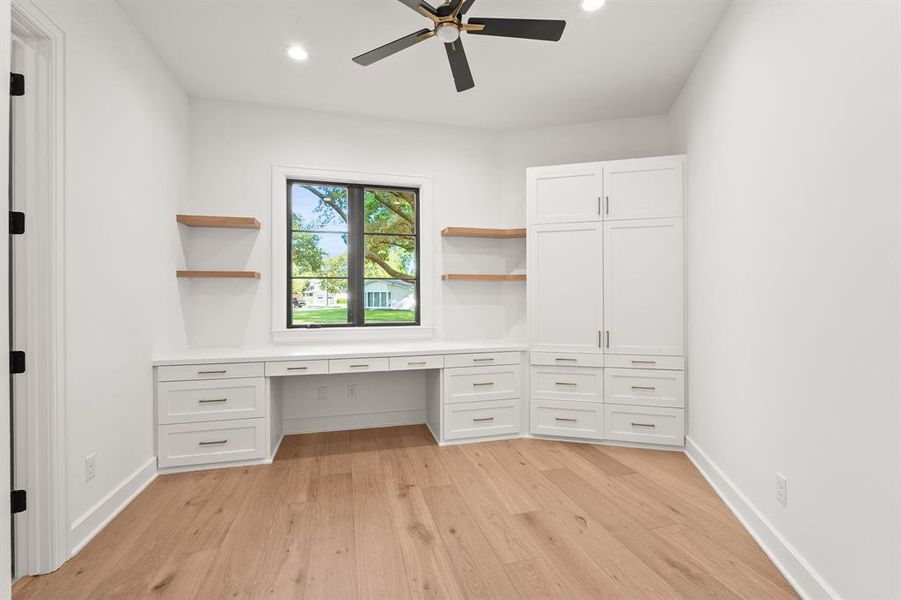 Unfurnished office with built in study area, light wood-type flooring, recessed lighting, and a ceiling fan Unfurnished office with built in study area, light wood-type flooring, recessed lighting, and a ceiling fan