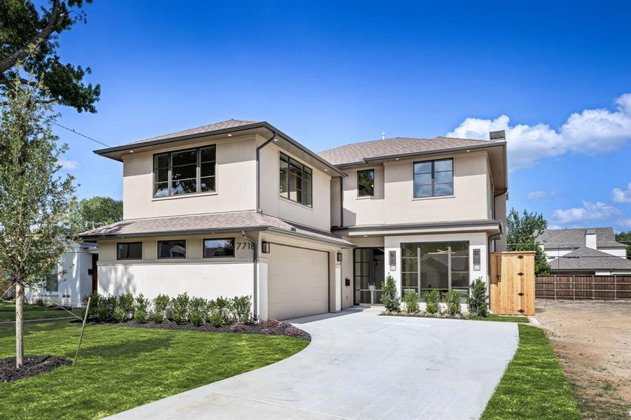 View of front of home with concrete driveway, stucco siding, an attached garage, a chimney, and a shingled roof View of front of home with concrete driveway, stucco siding, an attached garage, a chimney, and a shingled roof