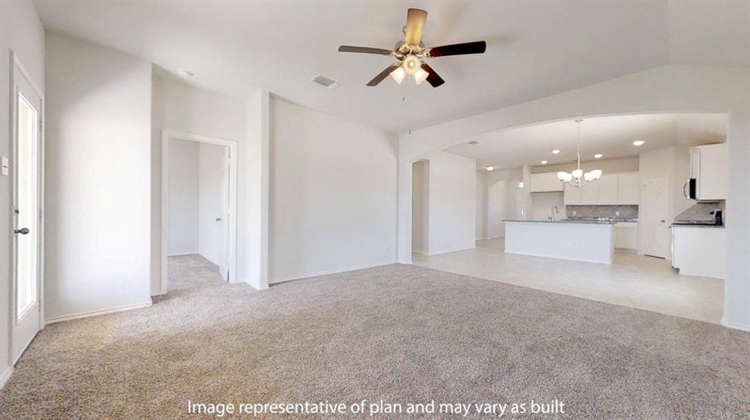 Unfurnished living room featuring a chandelier, light colored carpet, a ceiling fan, arched walkways, and recessed lighting Unfurnished living room featuring a chandelier, light colored carpet, a ceiling fan, arched walkways, and recessed lighting