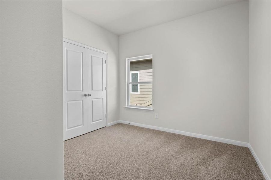 Unfurnished bedroom featuring carpet floors and a closet